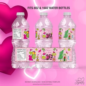May include: Clear plastic water bottles with pink labels featuring a Grinch theme. The labels include text that reads "Kaylee's a mean ONE" and "Birthday Facts". The bottles are designed to fit 8oz and 16oz sizes.