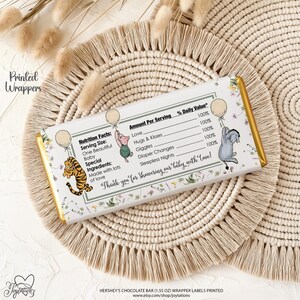 May include: A rectangular chocolate bar wrapper featuring a nutrition facts label with text including Love, Hugs & Kisses, Giggles, Diaper Changes, and Sleepless Nights. Illustrations of a tiger, piglet, and donkey holding balloons are present.