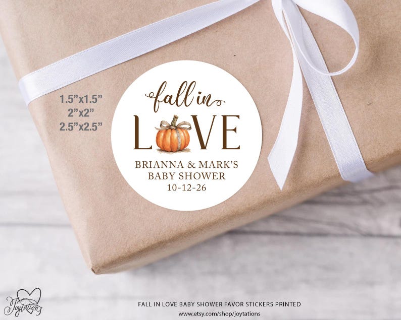 May include: A round white sticker featuring a watercolor orange pumpkin replacing the letter O in the text fall in LOVE. Below the pumpkin, the text reads BRIANNA & MARK'S BABY SHOWER 10-12-26. Available sizes listed are 1.5"x1.5", 2"x2", and 2.5"x2.5".