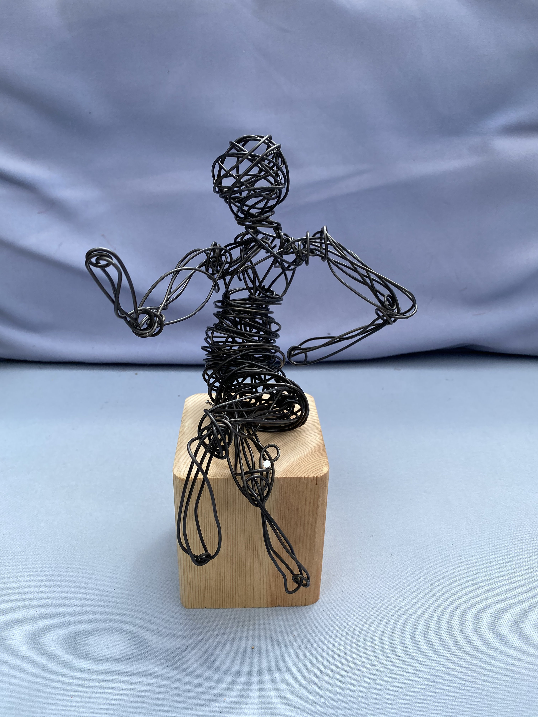 A sculpture of a hand with a wire wrapped around it photo – Free