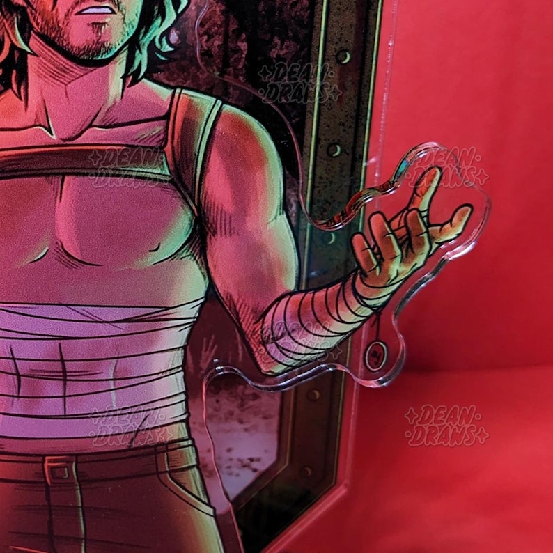 May include: A clear acrylic cutout of a hand, with a stylized illustration of a person in the background. The person is wearing a white bandage on their arm and a tank top. The background is red.