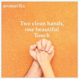 Two clean hands held together on a bright orange background, symbolizing care and connection. The image highlights the benefits of Aromavita’s PureDefend Soap for maintaining soft, clean, and healthy hands after every wash.