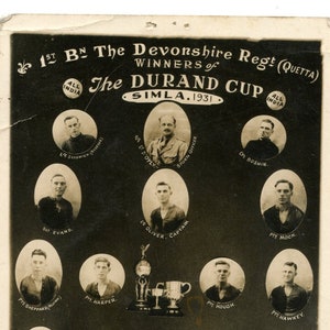 May include: Vintage black and white photograph of the 1st Battalion The Devonshire Regiment, winners of the Durand Cup in Simla, 1931. The image features portraits of the team members and the trophy.