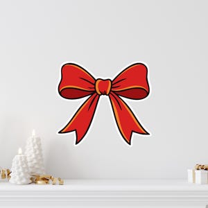 May include: A red bow with a yellow outline and a white border. The bow is a classic design, perfect for gift wrapping or holiday decorations. The bow is a bright, cheerful color.