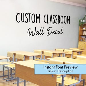 May include: A classroom scene featuring wooden desks and chairs. The wall displays the text "CUSTOM CLASSROOM Wall Decal" in black script. A light blue banner at the bottom reads "Instant Font Preview Link in Description."