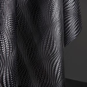 May include: Close-up of a black woven fabric with a textured surface. The fabric is draped, creating curved lines and shadows. The weave pattern is intricate, with a repeating design. The overall effect is a modern, abstract textile.