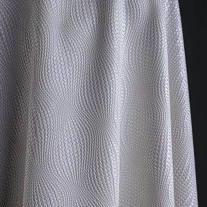 May include: Close-up of a white fabric with a woven texture. The fabric is draped, creating soft waves and shadows. The weave pattern is consistent throughout, giving a sense of depth and dimension. The material appears to be smooth and possibly synthetic.