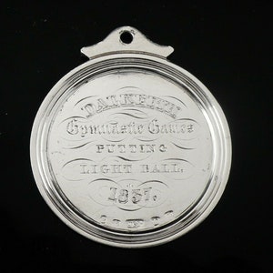 May include: Silver medal with the inscription "Dalkeith Gymnastic Games Putting & Light Ball. 1857."