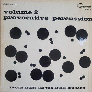 May include: Vintage vinyl record album cover for "Volume 2 Provocative Percussion" by Enoch Light and The Light Brigade. The cover features a cream background with black circles of varying sizes. The text includes "STEREO" and "Command Records".