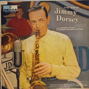 May include: A vintage vinyl record cover featuring a black and white photo of a man playing a saxophone. The cover is titled "The Great Jimmy Dorsey" and features the text "presenting JIMMY DORSEY and his orchestra featuring BOB EBERLY, HELEN O'CONNELL and KITTY KALLEN".