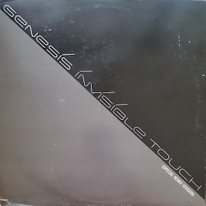 May include: A black and gray record album cover with the text "Genesis Invisible Touch (Special Remix Version)" in white.