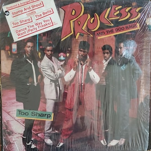 May include: Album cover for "Process" by Process and The Doo Rags. The cover features a group of men in suits and coats. The album title is in red and yellow. The tracklist includes "Stomp And Shout" and "Too Sharp".