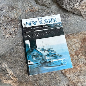 May include: The New Yorker magazine cover from November 30, 1963, featuring a black and white illustration of a boat yard with a train bridge in the background. The cover art is by artist "Getz".