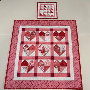 May include: A set of three ceramic mugs with a speckled, matte finish. The mugs are in shades of cream, light gray, and dark gray. Each mug has a simple, minimalist design, perfect for coffee or tea.