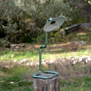 Steampunk lamp workshop, assembly of cast iron fittings.