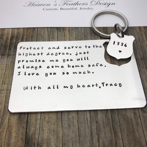 May include: A silver keychain with a small badge that says "1336" and a heart. The keychain has a message that reads "Protect and serve to the highest degree, Just promise me you will always come home safe. I love you so much. With all my heart, Tracy."