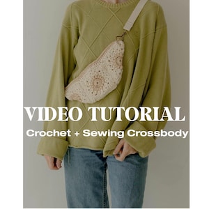 May include: A person wearing a green sweater and blue jeans is wearing a crocheted cream-colored fanny pack with a white strap. The text "VIDEO TUTORIAL Crochet + Sewing Crossbody" is displayed below the image.