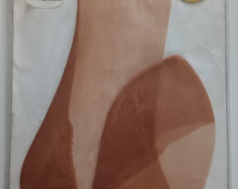 May include: A package of Tandra Nylons in Honey color. The package includes a pair of sheer, fashionable stockings. The label reads "Starliner Fashioned Sheers" and "8 1/2 Honey". The stockings are a light brown color.