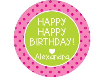 May include: A round sticker with a pink polka dot border. The center features a green circle with the words "HAPPY HAPPY BIRTHDAY!" in white, a white heart, and the name "Alexandra".