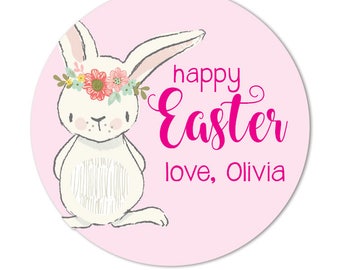 May include: A pink circle with a white bunny wearing a flower crown. The text "happy Easter love, Olivia" is written in pink.
