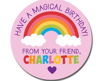 May include: A round, pink sticker with a rainbow and the text "Have a Magical Birthday!" in purple. The text "From Your Friend, Charlotte" is below the rainbow in colorful letters, with a purple heart at the bottom.