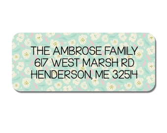 May include: A light blue return address label with a white floral pattern. The text reads "THE AMBROSE FAMILY 617 WEST MARSH RD HENDERSON, ME 32514".