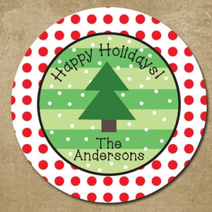 May include: Round red and white polka dot sticker with a green and white striped circle in the center. The inner circle has a green Christmas tree with the text "Happy Holidays!" above the tree and "The Andersons" below the tree.