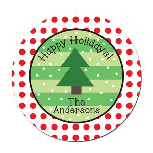 May include: A round, white sticker with red polka dots. The center of the sticker has a green and white striped background with a green Christmas tree and white snowflakes. The text "Happy Holidays!" is written in a black cursive font around the tree. The text "The Andersons" is written in black below the tree.