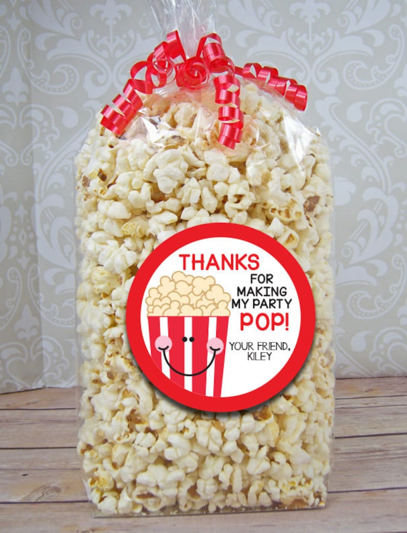May include: A red and white popcorn party favor bag with a round sticker that says "Thanks for making my party pop! Your friend, Kiley".