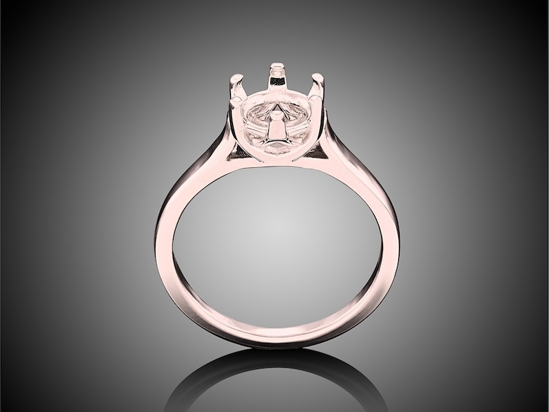 May include: A rose gold ring setting with a prong setting for a center stone.