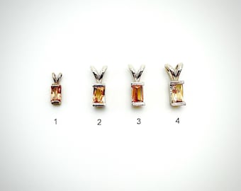 May include: Four rectangular gemstone pendants with silver-colored bails are displayed against a white background. The gemstones vary in size and shade, ranging from orange to yellow. Each pendant is numbered from one to four.