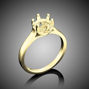 May include: A gold ring setting with a round center stone setting. The setting has six prongs and a smooth band.