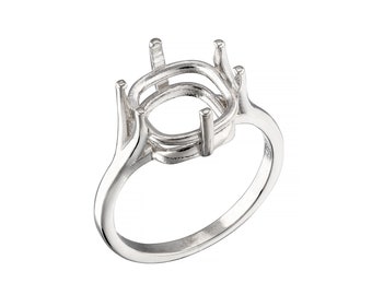 May include: Silver ring setting with a large oval shaped bezel. The setting is designed to hold a gemstone or other material.