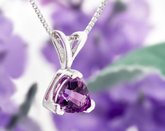 May include: A silver necklace with a triangular amethyst pendant. The pendant is set in a silver bezel and has a faceted cut. The necklace is on a chain with a box clasp.