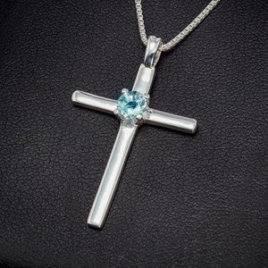 Aquamarine Silver Cross Necklace. Handmade, sterling silver pendant with a natural, 5mm round faceted, aquamarine from Brazil. Chain options