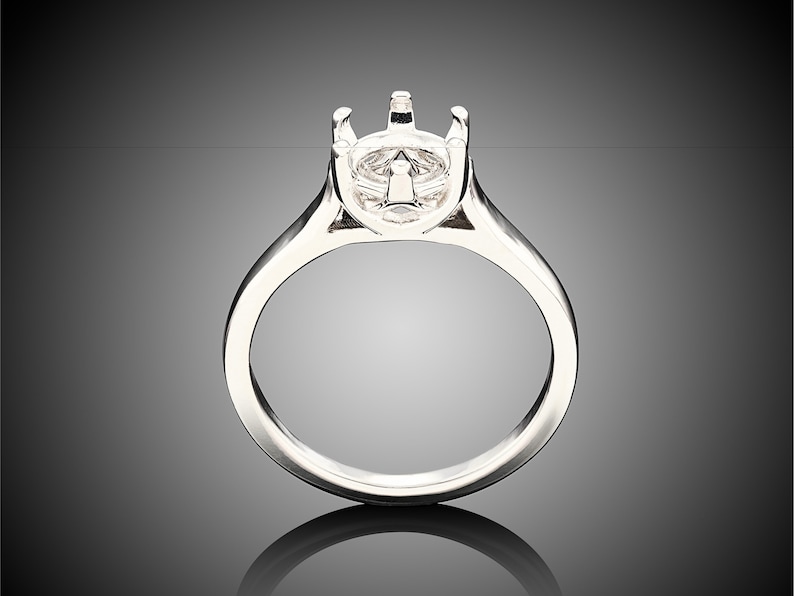 May include: A silver ring with a prong setting for a large gemstone. The ring is smooth and polished.