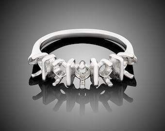 May include: A silver ring with five prongs for setting a gemstone. The prongs are in a unique, geometric design.