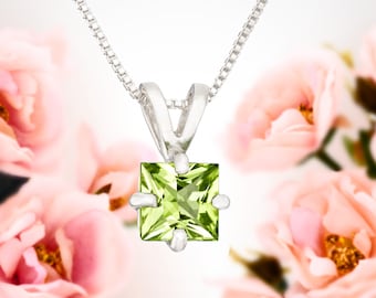 May include: A silver necklace with a square green peridot pendant.