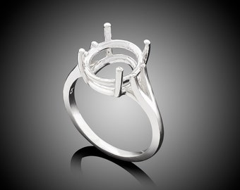 May include: A silver ring with an oval-shaped setting. The setting is designed to hold a gemstone.