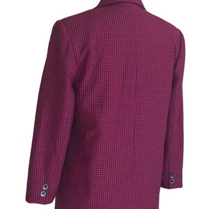 May include: A red and black checkered blazer with a single button closure. The blazer has long sleeves and a classic fit.