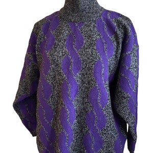 May include: A gray and black turtleneck sweater with a repeating purple pattern. The sweater is displayed on a mannequin and has long sleeves. The pattern is a series of vertical, interconnected, wavy lines.