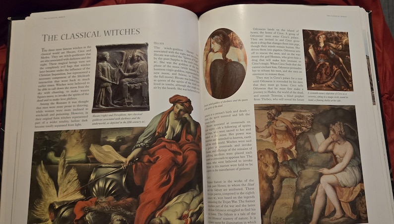 May include: An open book with the title "THE CLASSICAL WITCHES" on the top left. The pages display various illustrations and text, including images of classical art and paintings. The book is open on a dark surface.