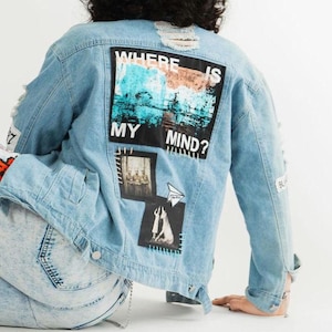 May include: A light blue denim jacket with distressed details and various patches. The largest patch features a graphic design with the text "Where is my mind?" in black and white.