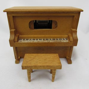 May include: A white ceramic mug with a black handle and the text "But First, Coffee" in a black, bold font. The mug is on a white surface. The mug is 4 inches tall.