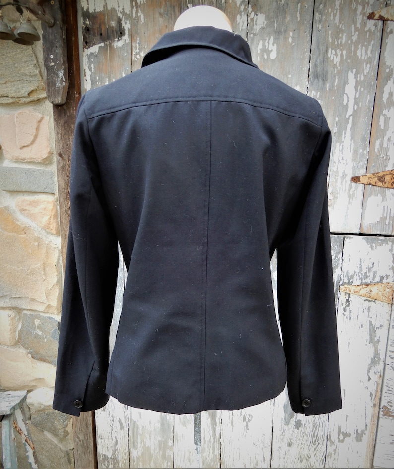 May include: A black blazer with a long sleeve and a button-up collar.