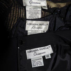 May include: Three black and white clothing labels with the text "ADRIANNA PAPELL Occasions" and size 10. The first label is for a silk dress, the second label is for a silk dress, and the third label is for a polyester dress.