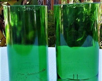 May include: Two green glass bottles, cut and polished to create drinking glasses. The bottles are labeled "Product of Ireland".