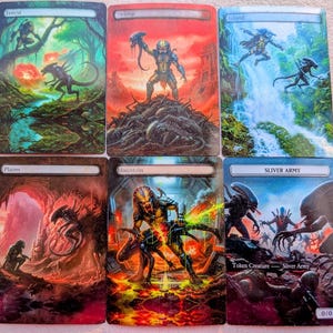 May include: Six fantasy art trading cards featuring scenes of a forest, swamp, island, plains, mountain, and a sliver army. Each card depicts a Predator and Alien in a dynamic, action-packed setting with vibrant colors and detailed illustrations.