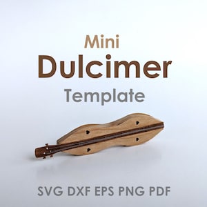 May include: A miniature wooden dulcimer, a stringed musical instrument, with a light brown finish. The dulcimer is lying on a white surface. The text "Mini Dulcimer Template" is above the instrument, and the text "SVG DXF EPS PNG PDF" is below the instrument.