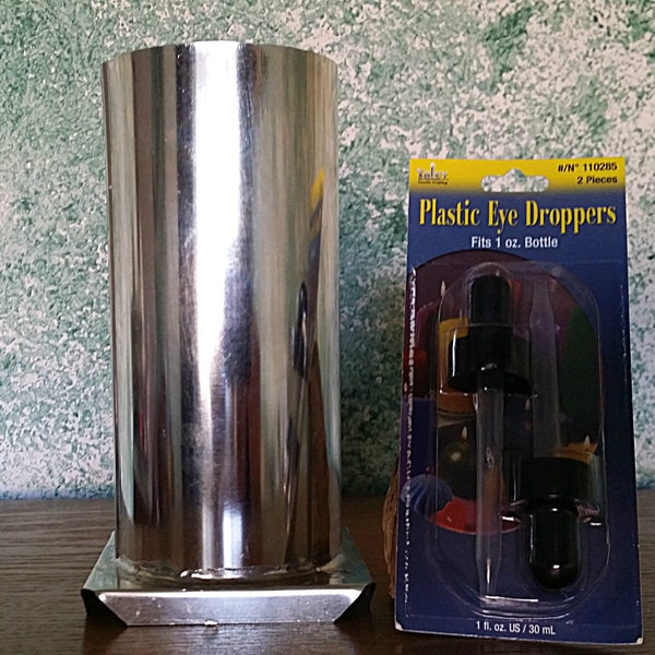 Candle Mold Metal Cylinder, plastic droppers, and wicks in various sizes.